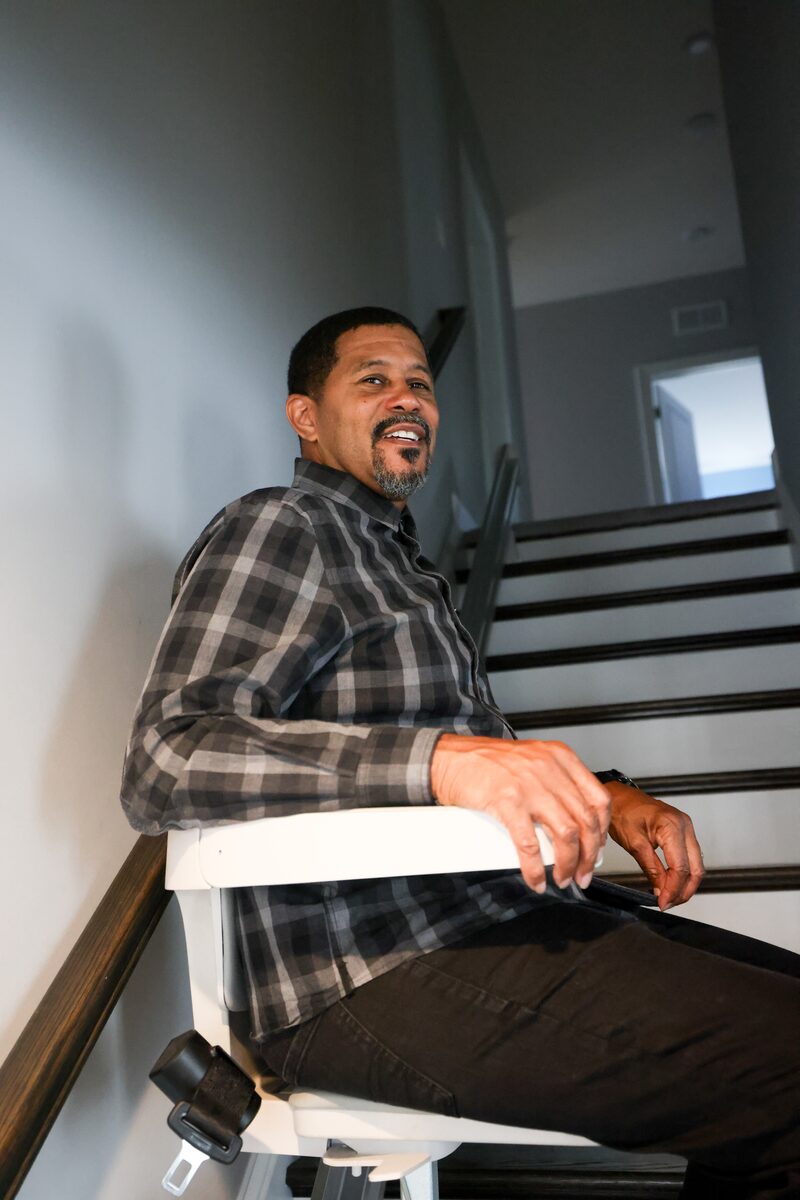 Adult man using a stairlift in his home